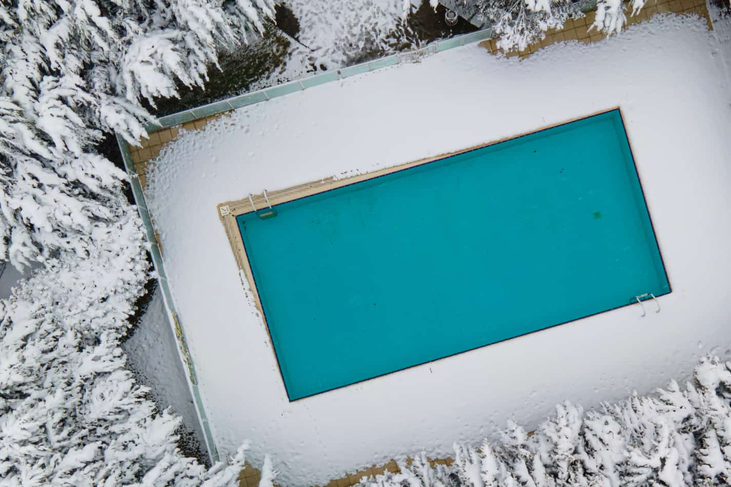 Overhead view of a pool in winter without a cover